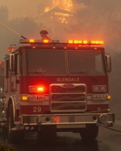 A Glendale firefighter battles the 2025 fire in Altadena