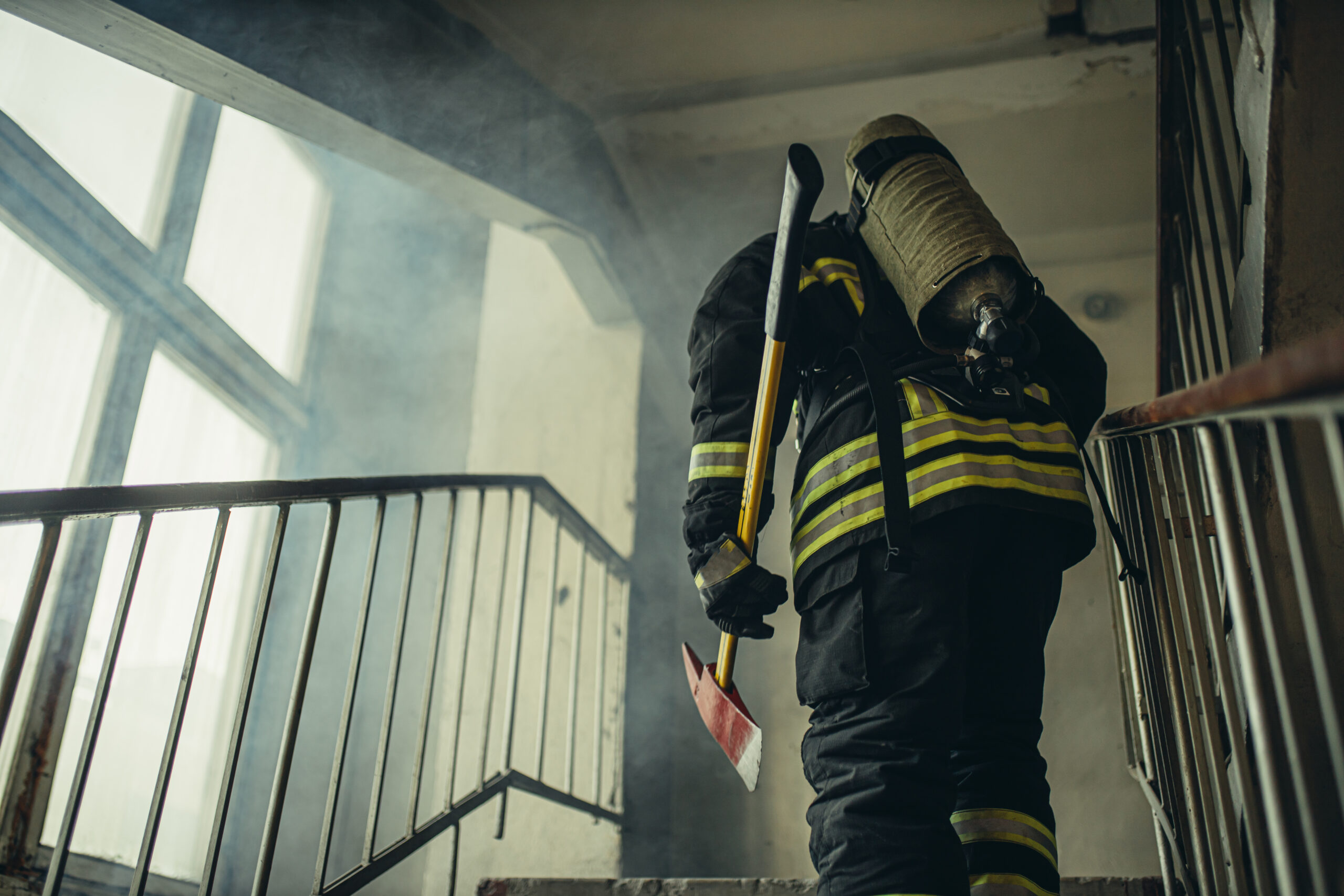 young extinguisher with hammer go to save and protect wearing uniform, on the landing