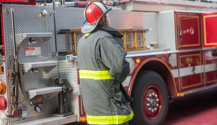 Firefighter walking past his truck