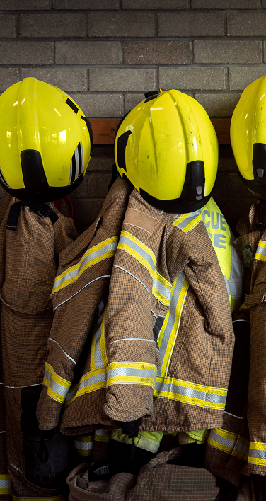 Firefighter gear hanging on a wall